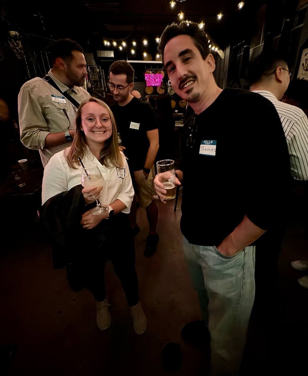 Two guests with name badges and drinks