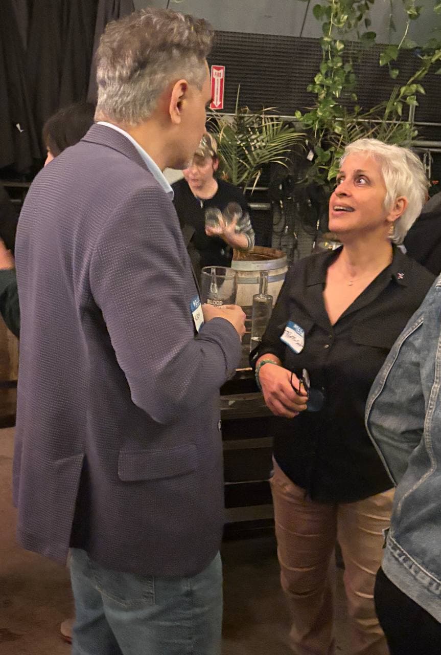 Two operators talking under the venue plants