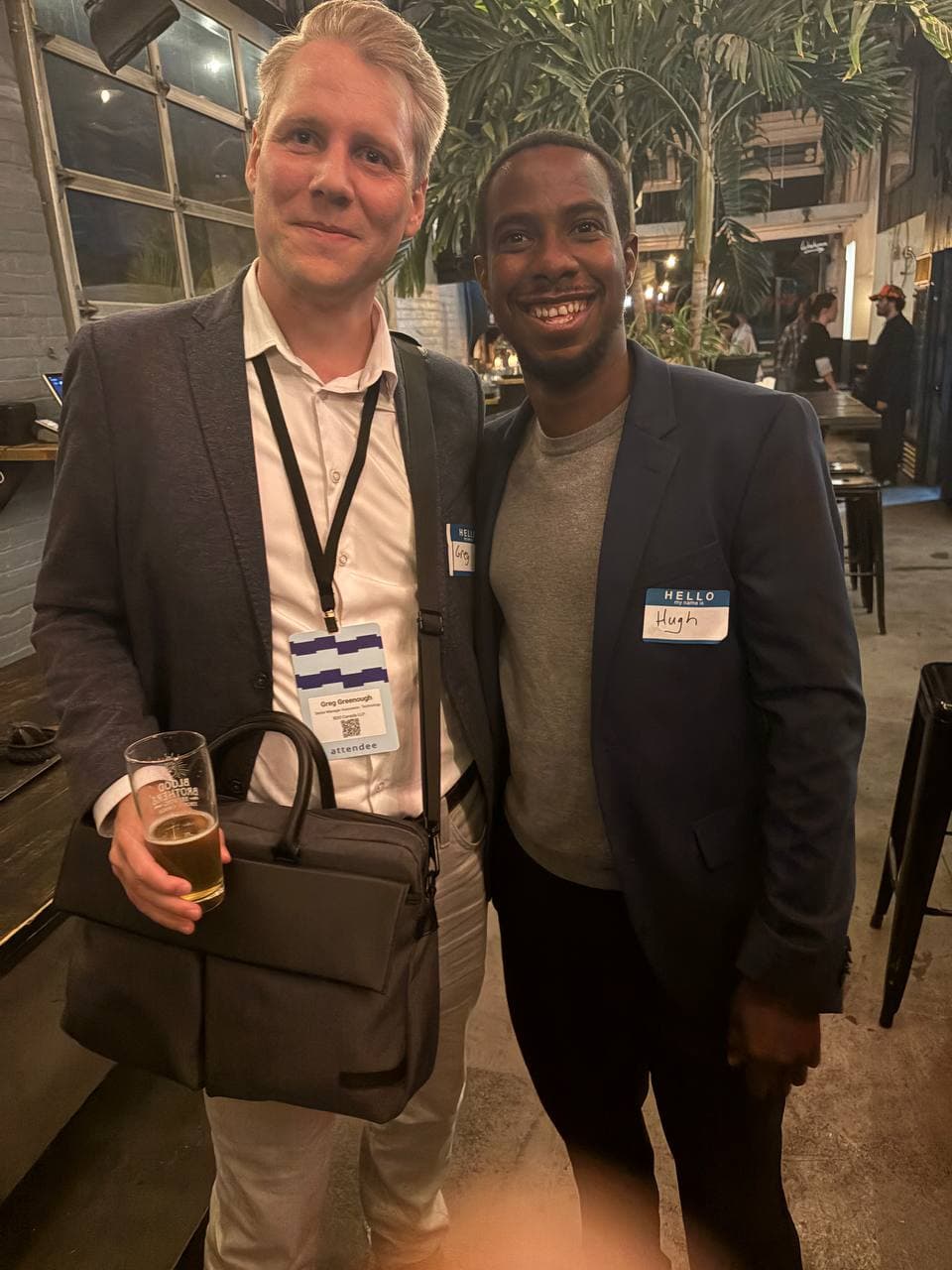 Two founders meeting beside the venue bar
