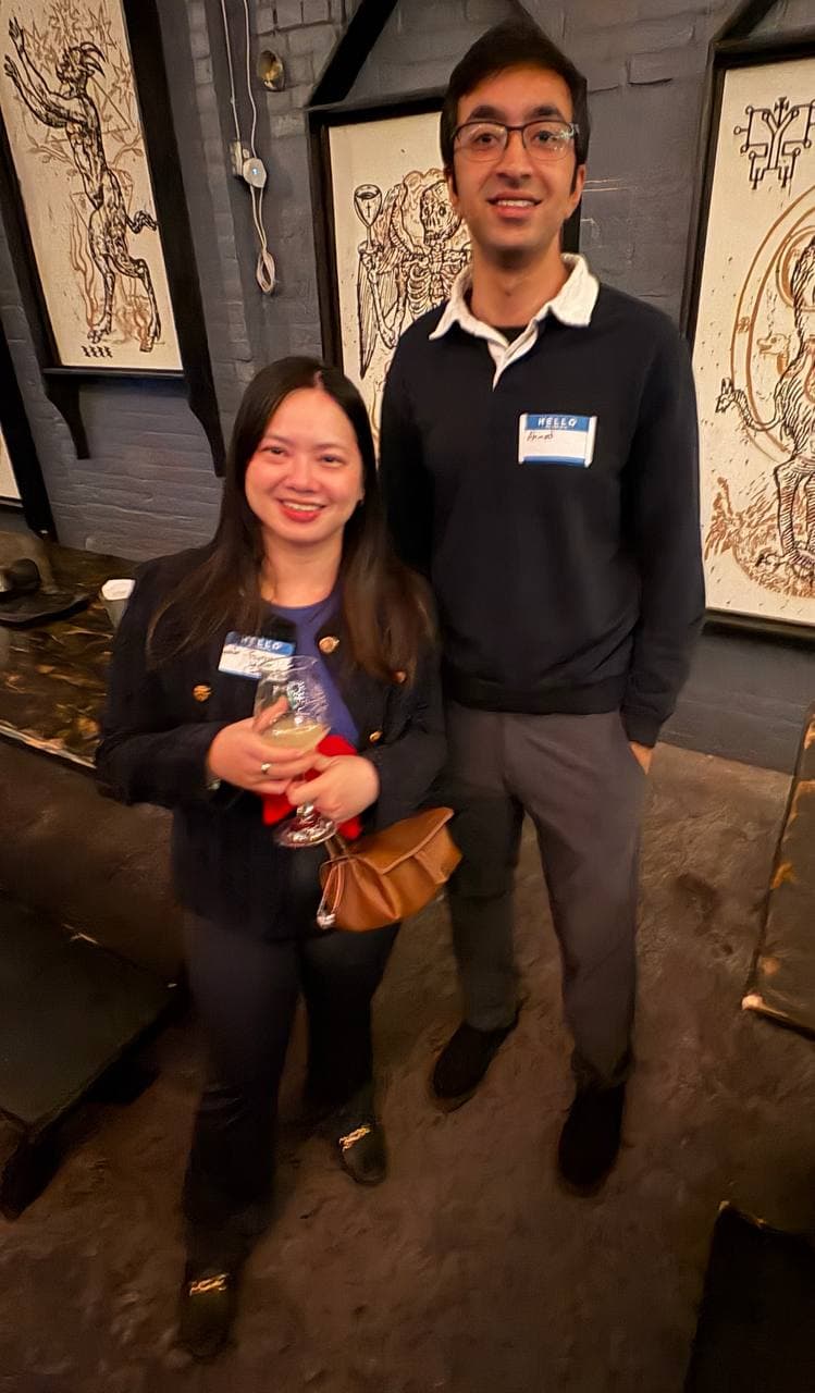 Guests with badges under the venue artwork