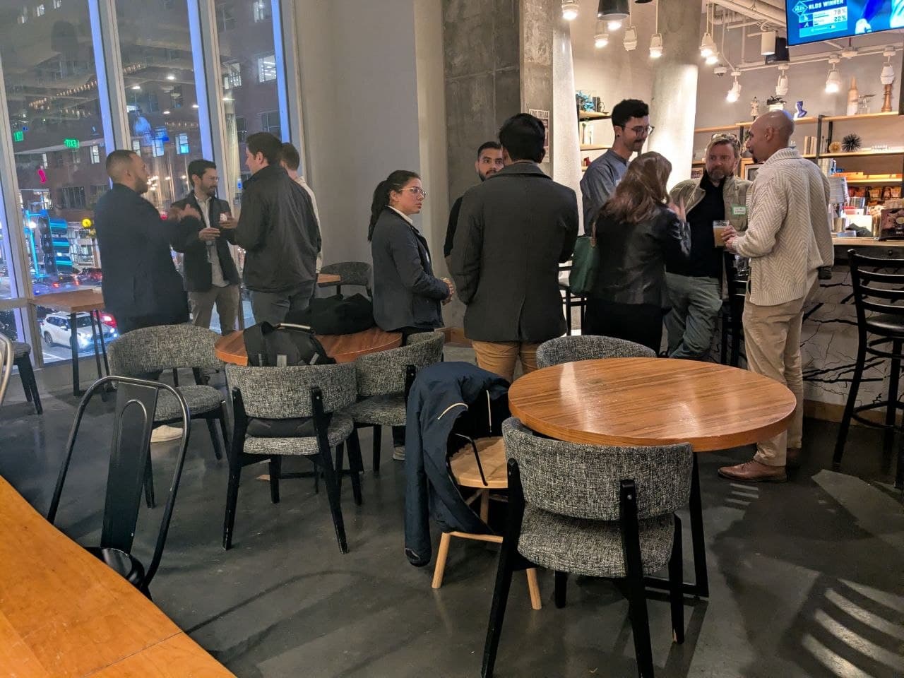 Guests networking by the bar in Boston
