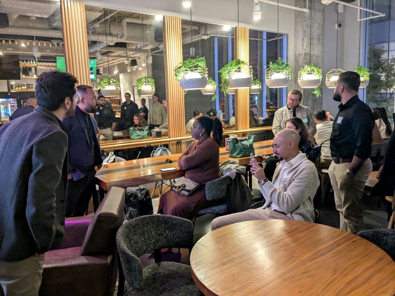 Guests listening to startup pitch at Bar Moxy