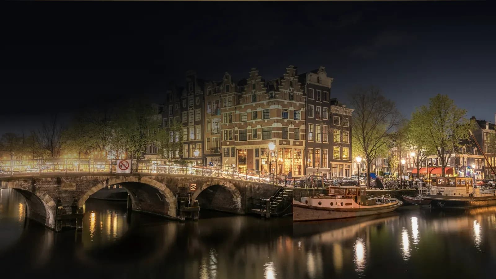 Amsterdam canal houses and a bridge at night