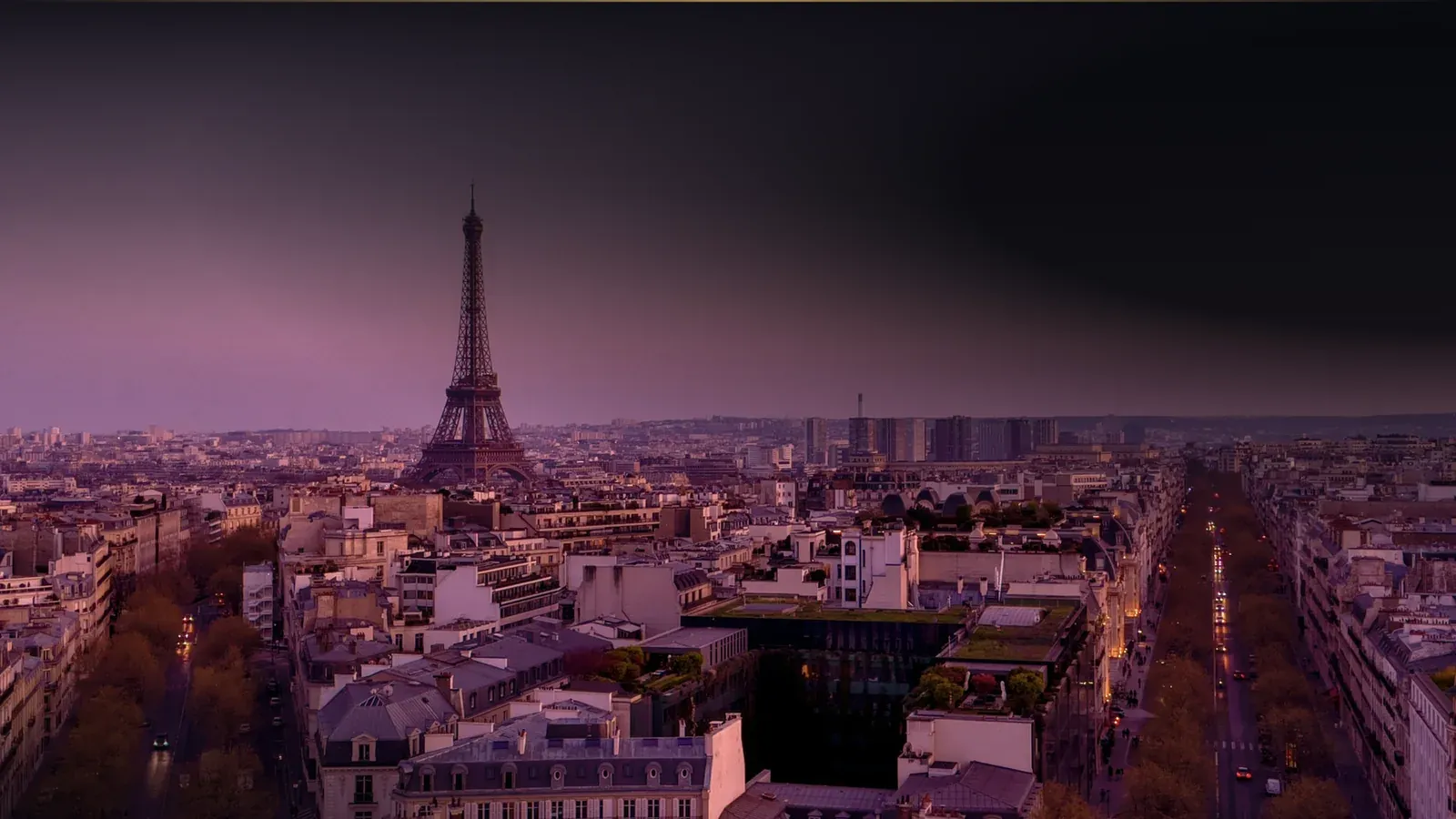 Paris rooftops and the Eiffel Tower at dusk